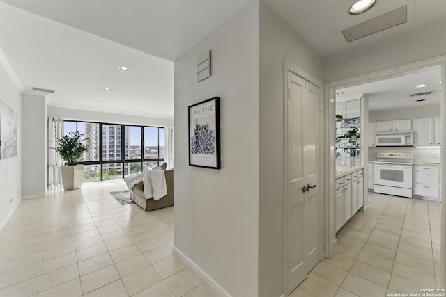 hall with recessed lighting, baseboards, visible vents, and light tile patterned floors
