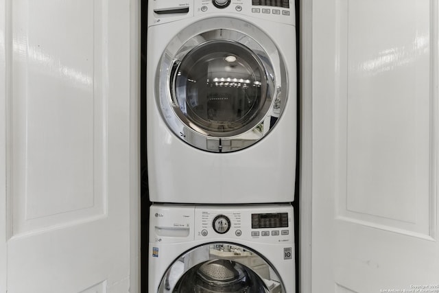 clothes washing area with laundry area and stacked washer / dryer