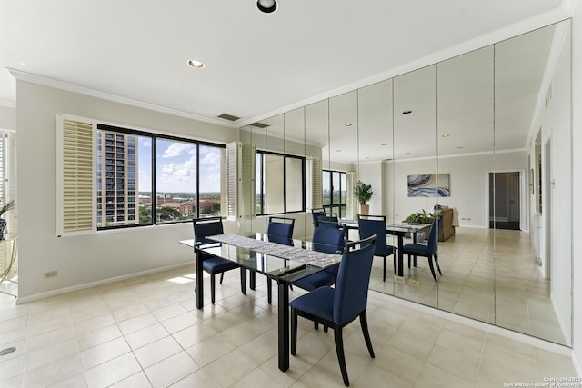 dining area with baseboards, visible vents, and ornamental molding