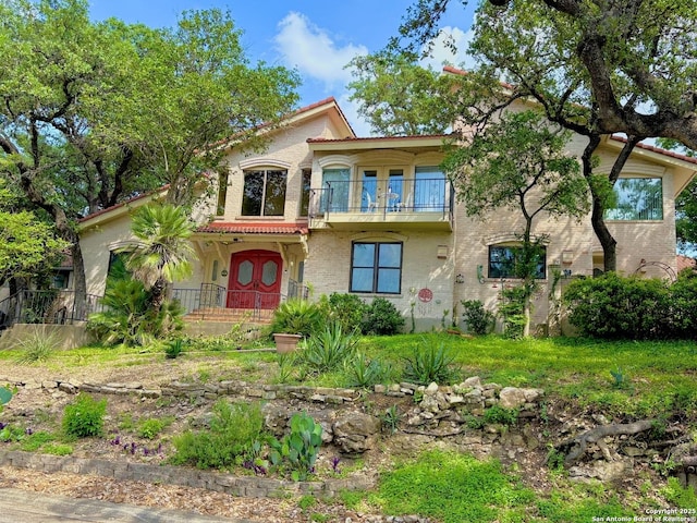 11402 Mission Trace St, San Antonio, TX 78230 - mediterranean / spanish house featuring brick siding and a balcony