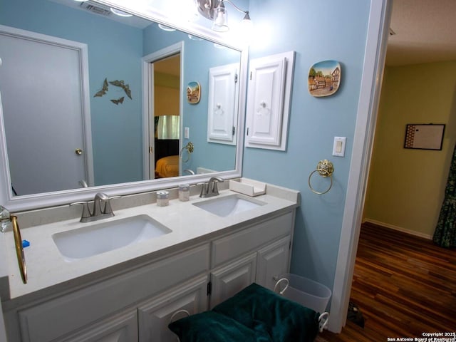 11402 Mission Trace St, San Antonio, TX 78230 - full bathroom featuring double vanity, baseboards, a sink, and wood finished floors