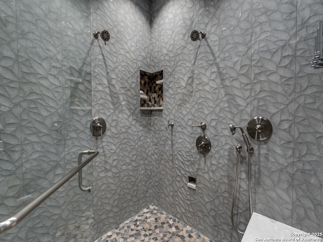 full bath with a tile shower