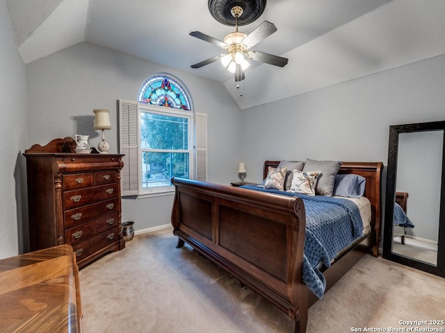 bedroom with a ceiling fan, baseboards, carpet, and vaulted ceiling