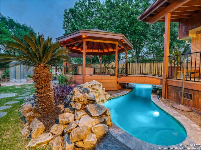 view of pool featuring a gazebo and an outbuilding
