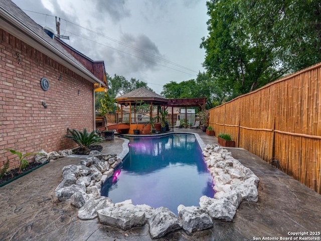 view of pool featuring a gazebo, a fenced backyard, and a fenced in pool