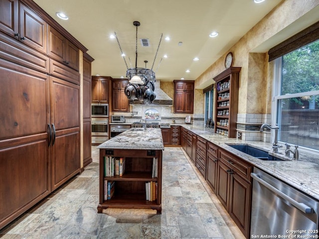 kitchen with open shelves, a sink, light stone countertops, and stainless steel appliances