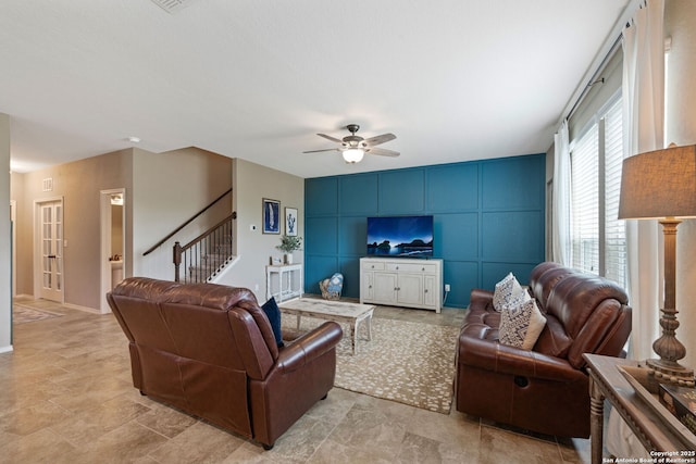 27342 Emilie Cyn, San Antonio, TX 78260 - living area with ceiling fan, a decorative wall, baseboards, stone finish flooring, and stairway