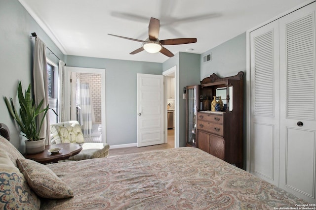 bedroom featuring ceiling fan, baseboards, wood finished floors, visible vents, and a closet