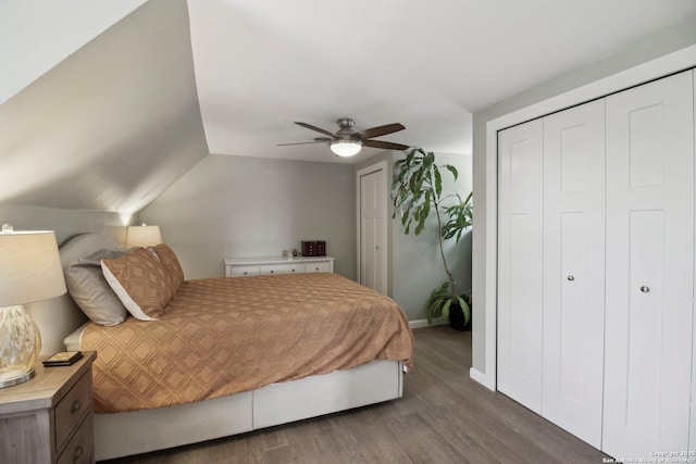 bedroom featuring baseboards, lofted ceiling, wood finished floors, and ceiling fan