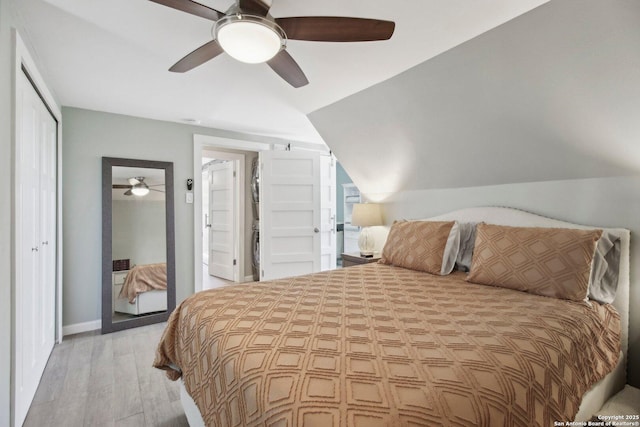 bedroom featuring a closet, ceiling fan, baseboards, and light wood-style floors