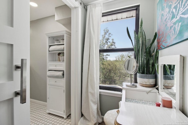 bathroom featuring baseboards and a wealth of natural light