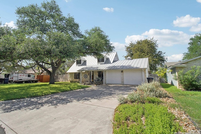 view of front of property featuring concrete driveway, a garage, fence, and a standing seam roof