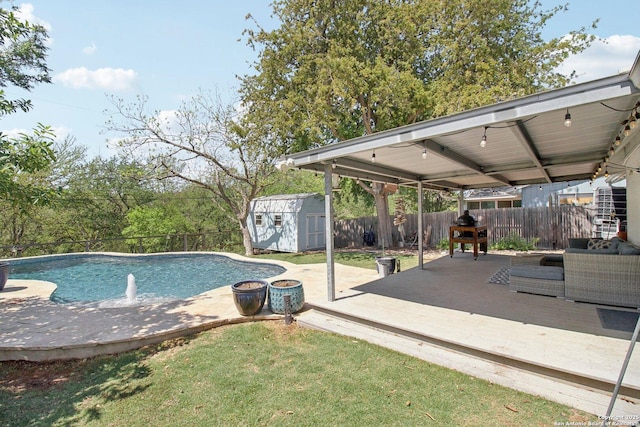 view of swimming pool with a storage shed, a deck, an outbuilding, a fenced in pool, and a fenced backyard