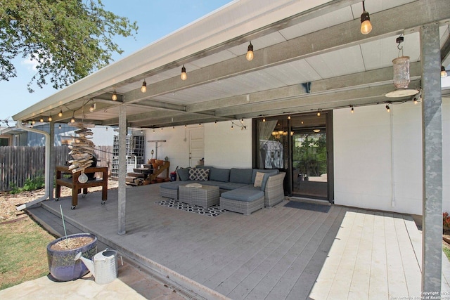 view of patio / terrace featuring an outdoor hangout area, fence, and a wooden deck