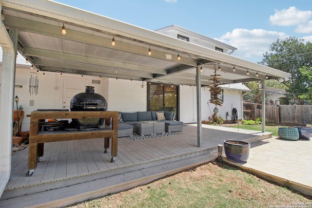 wooden terrace featuring fence and outdoor lounge area