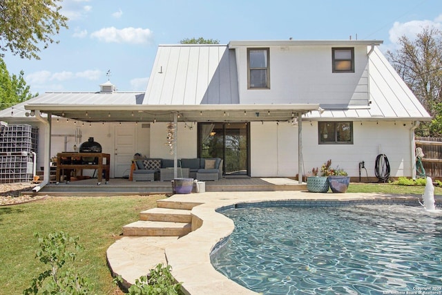 back of house with an outdoor living space, metal roof, a standing seam roof, a wooden deck, and an outdoor pool