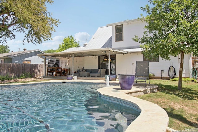 rear view of property with fence, a patio, an outdoor living space, a fenced in pool, and metal roof