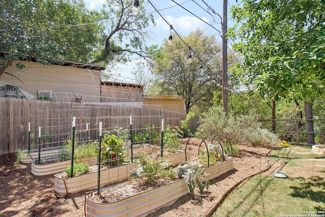 view of yard with fence and a garden
