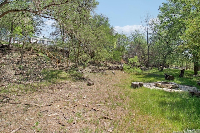 view of yard with a fire pit
