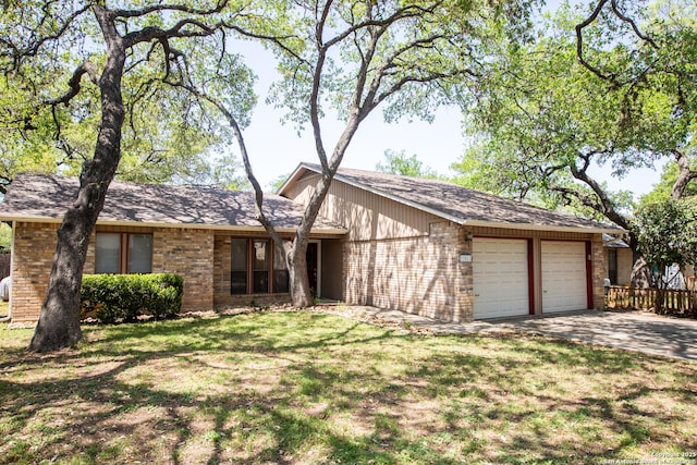 view of front of home with a garage, driveway, a front lawn, and brick siding