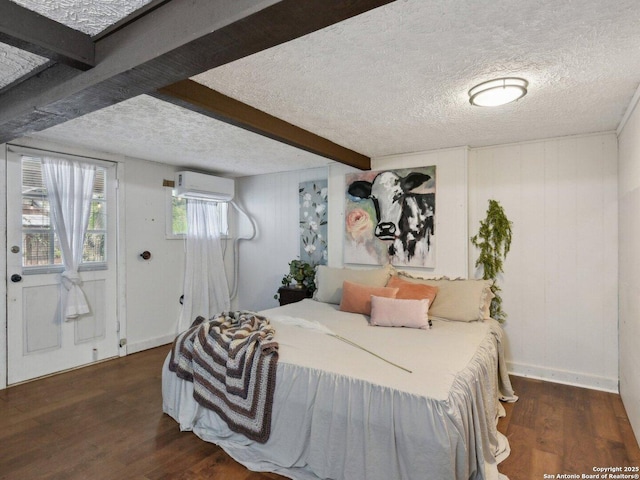 bedroom with wood walls, wood finished floors, beamed ceiling, an AC wall unit, and a textured ceiling