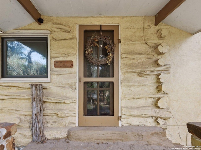 entrance to property featuring stone siding