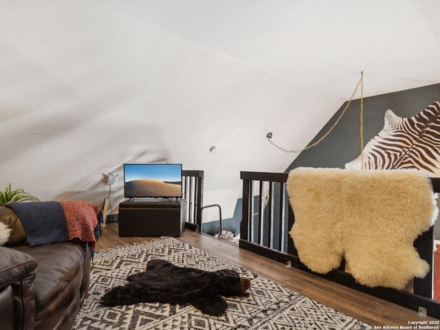 interior space featuring vaulted ceiling and wood finished floors