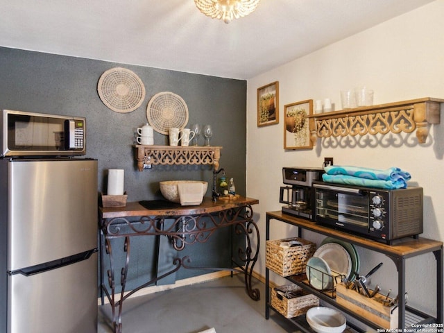 interior space featuring concrete floors and a toaster