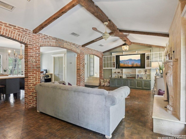 living room with arched walkways, visible vents, lofted ceiling with beams, and ceiling fan with notable chandelier