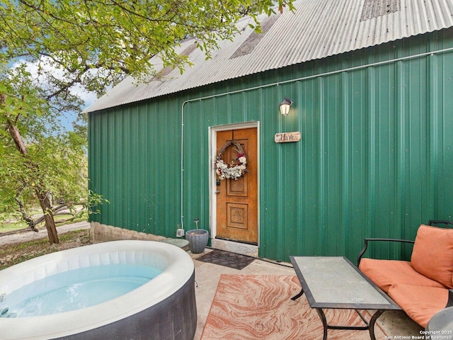 view of exterior entry with board and batten siding