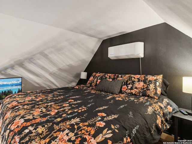 bedroom featuring a wall mounted AC and lofted ceiling