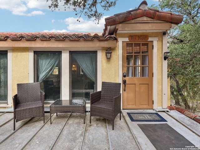 property entrance with stucco siding