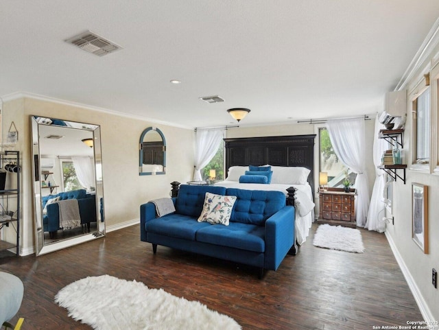 bedroom with visible vents, baseboards, crown molding, and wood finished floors