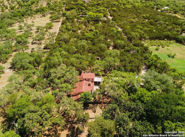birds eye view of property with a view of trees