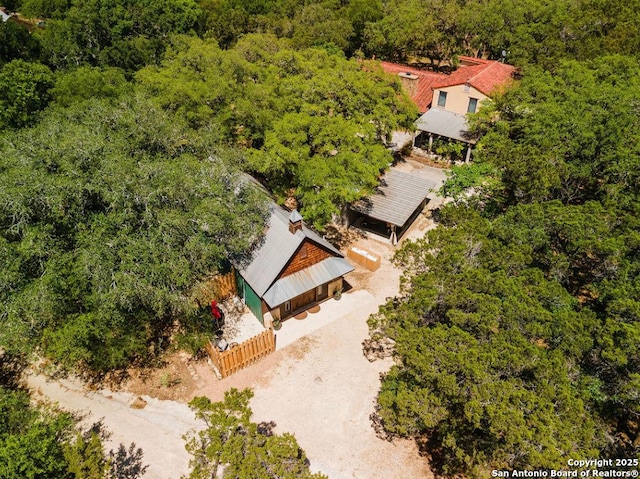 birds eye view of property featuring a wooded view