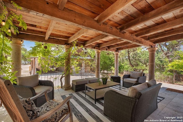 view of patio / terrace featuring outdoor lounge area and fence