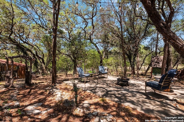 view of yard with a patio and an outdoor fire pit