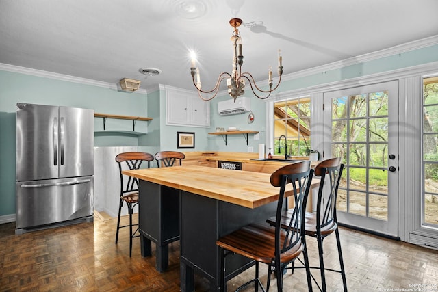 dining space featuring an inviting chandelier, ornamental molding, an AC wall unit, and plenty of natural light