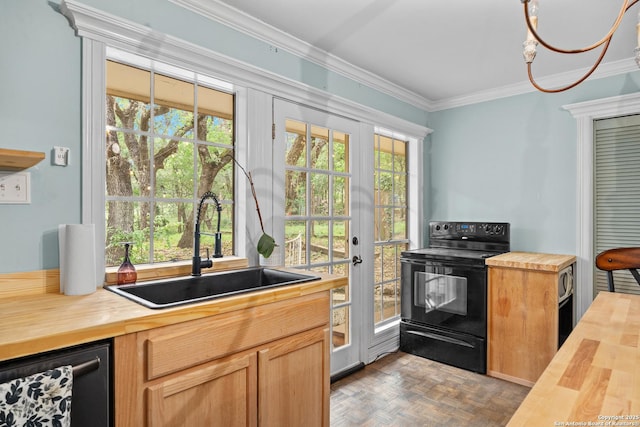 kitchen with crown molding, a sink, butcher block counters, and black appliances