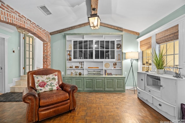living area with visible vents and vaulted ceiling with beams