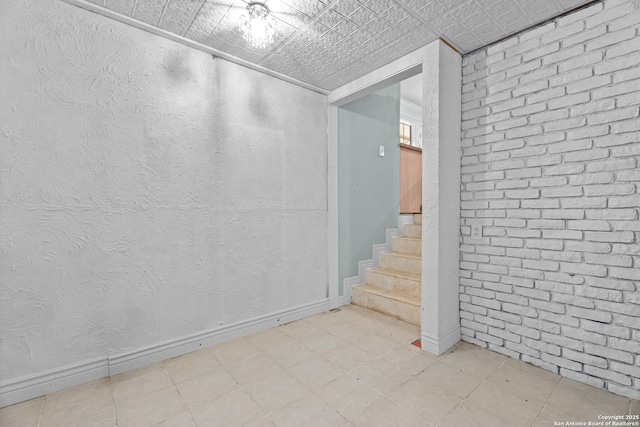 interior space with baseboards and stairs