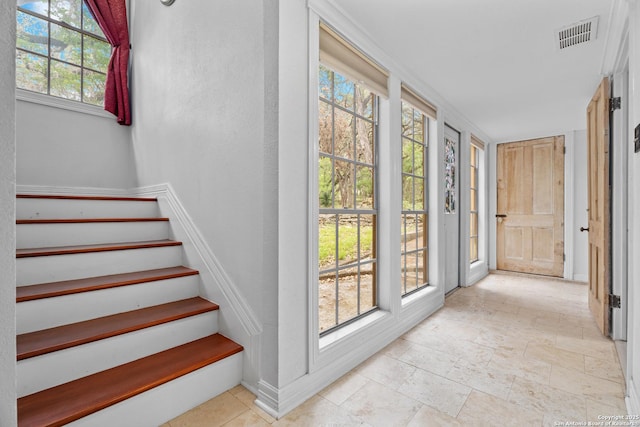 interior space with baseboards, stone finish floor, and visible vents