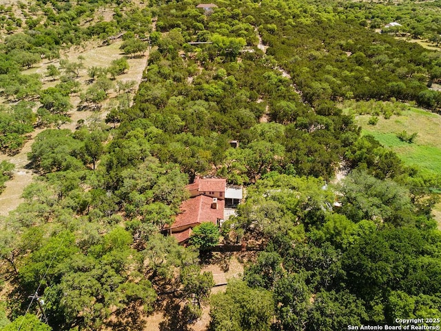 bird's eye view featuring a wooded view