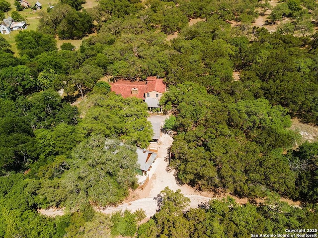 birds eye view of property with a wooded view