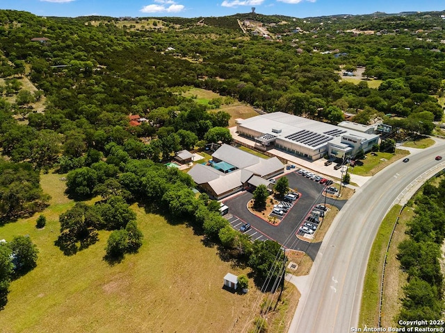 drone / aerial view featuring a forest view