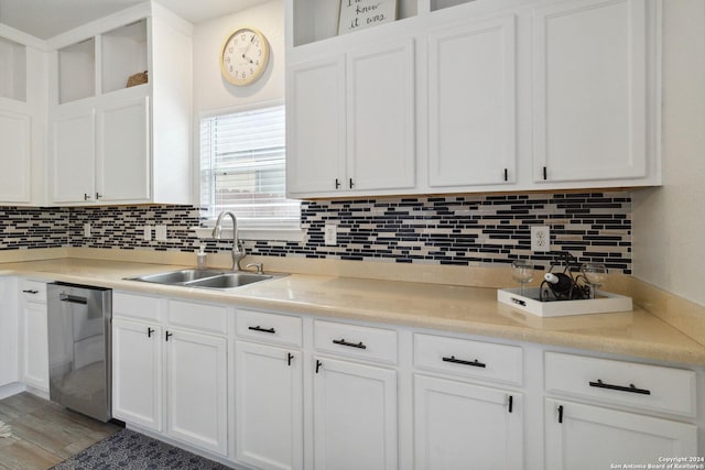 kitchen featuring a sink, white cabinets, and dishwasher