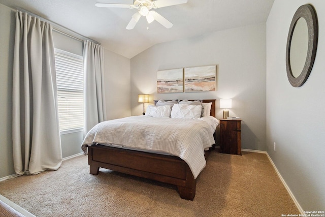 carpeted bedroom featuring a ceiling fan, baseboards, and lofted ceiling