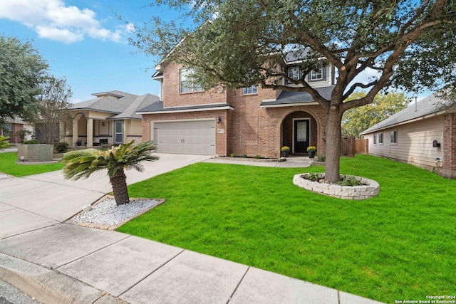 traditional home featuring a garage, a front lawn, fence, brick siding, and driveway