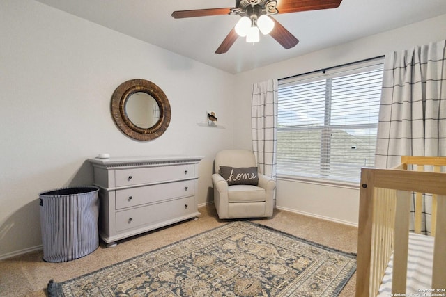 bedroom with a ceiling fan, baseboards, and light colored carpet