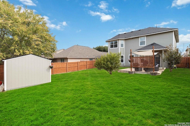 back of house featuring a yard, a patio, an outbuilding, and a fenced backyard